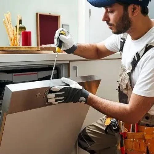 Technician repairing a dishwasher control panel